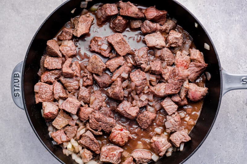 cooked beef and onion in a skillet.