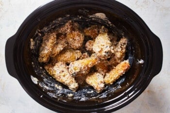 chicken wings covered in sauce in a slow cooker