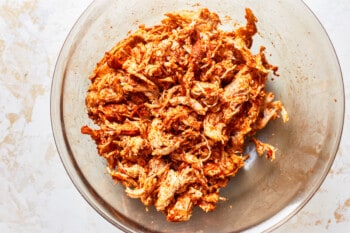 shredded chicken in a glass bowl