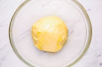 parker house roll dough in a glass bowl.