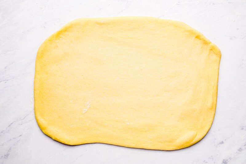 parker house roll dough rolled out into a rectangle.