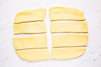 parker house roll dough cut into 8 strips.