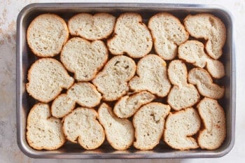 pieces of bread arranged into a deep baking dish