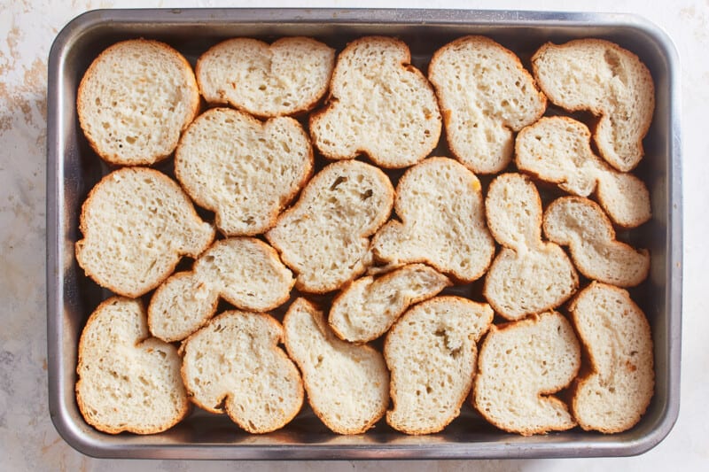 pieces of bread arranged into a deep baking dish
