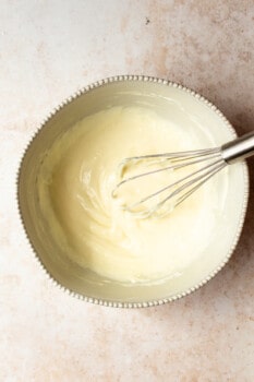 cream cheese mixture in a bowl with a whisk