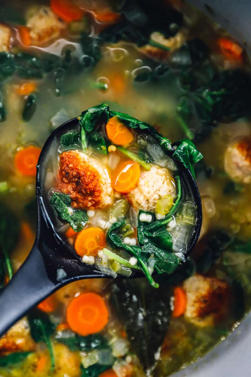 close up on a ladle of italian wedding soup