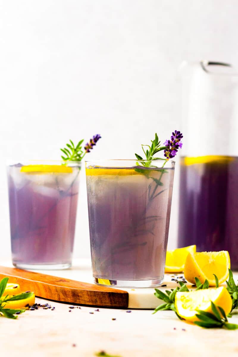 two glasses of lavender lemonade with lavender and lemons as garnish