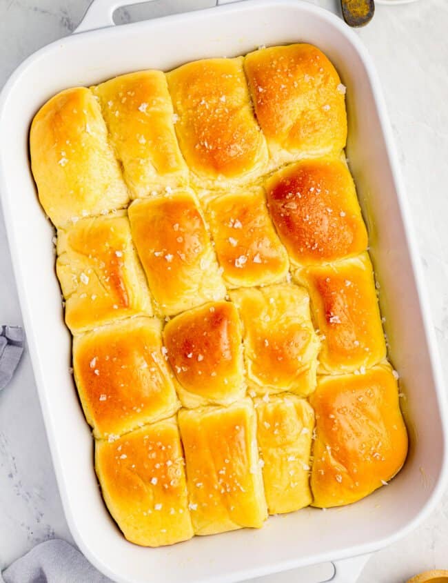 parker house rolls in a white baking pan.