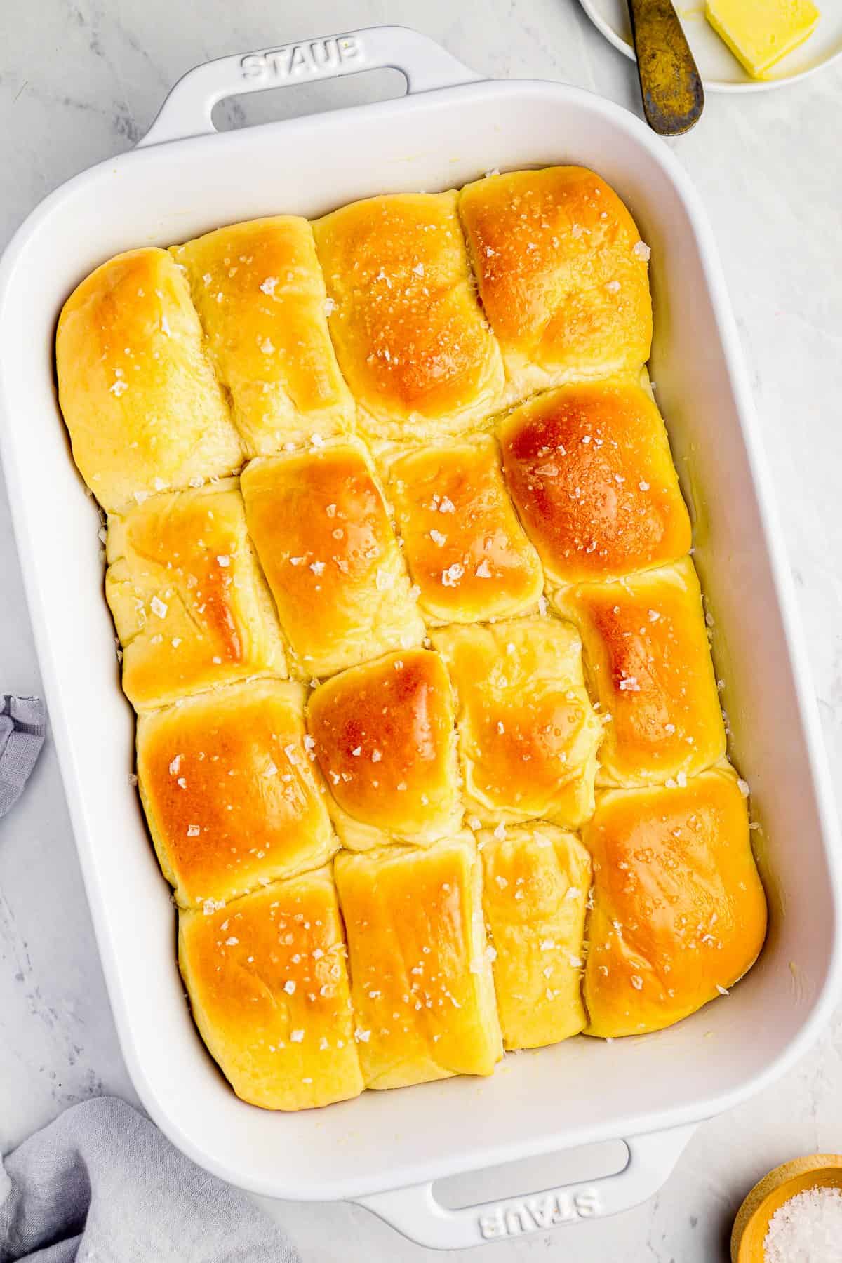parker house rolls in a white baking pan.