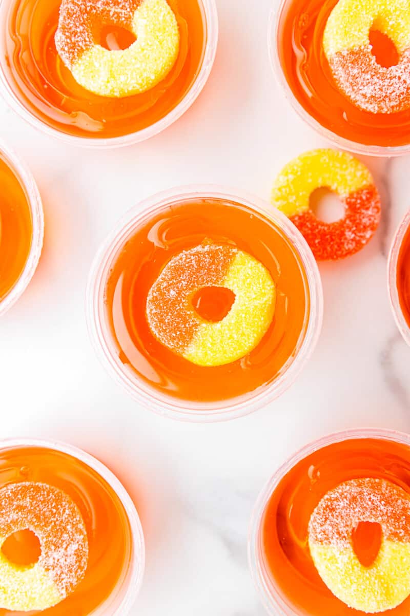 overhead view of peach jello shots with peach rings.