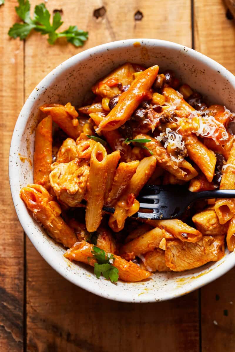 bowl of penne pasta with chicken, corn, and black beans