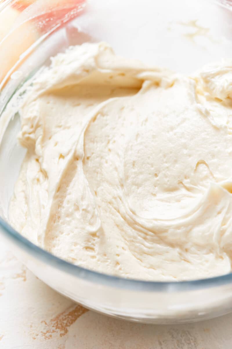 making vanilla frosting in a glass bowl