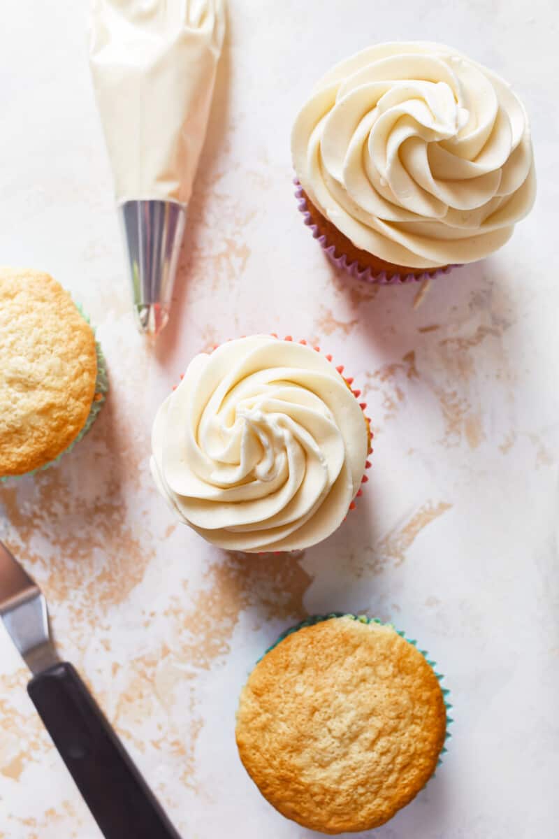 frosting cupcakes with homemade vanilla frosting