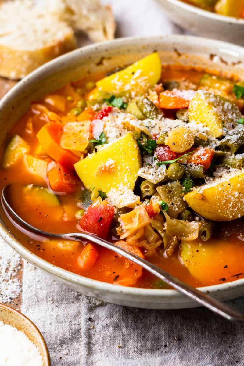 a bowl of vegetable soup with a spoon