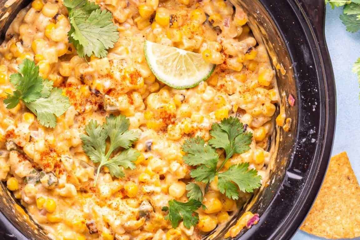 Close up of crockpot corn dip in a crockpot with cilantro.