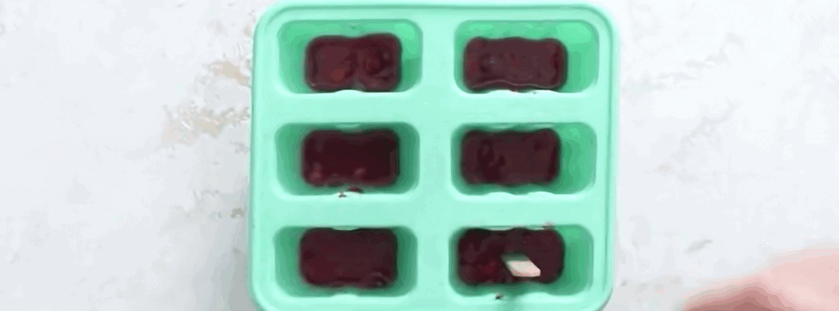 Strawberry layer of the frozen margaritas with a popsicle stick in the silicone mold. - 7