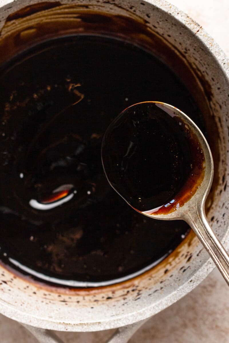 close up on a. spoon over a saucepan of balsamic glaze
