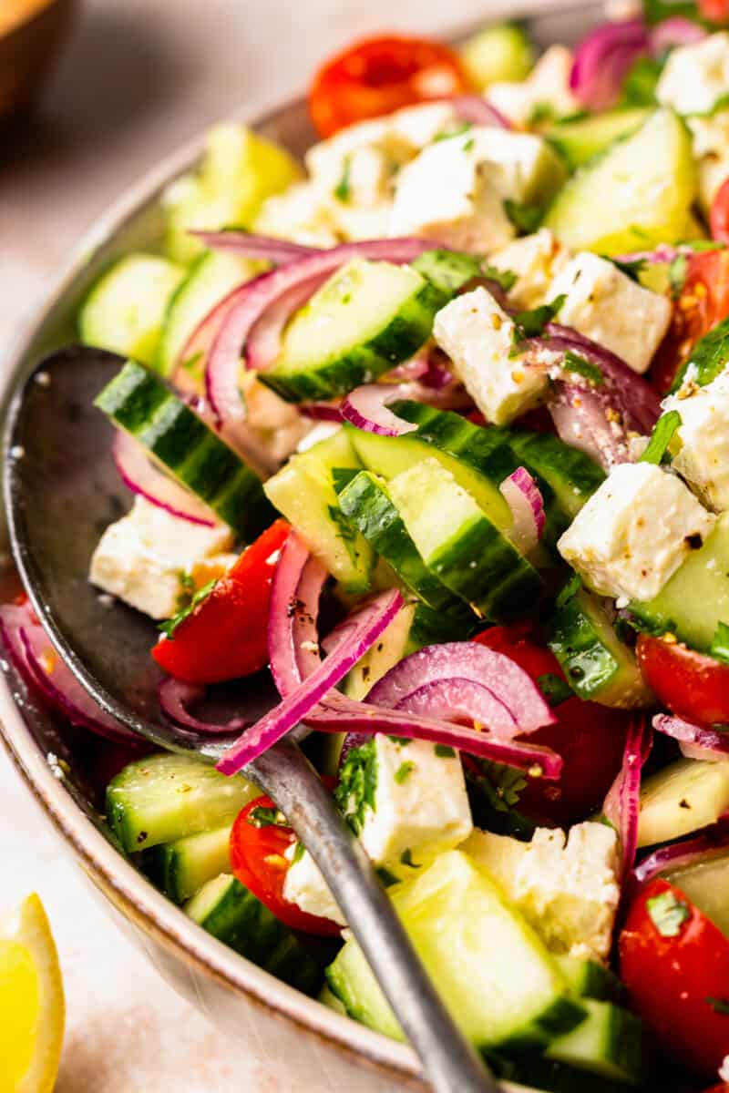 close up on a serving spoon sitting in a salad