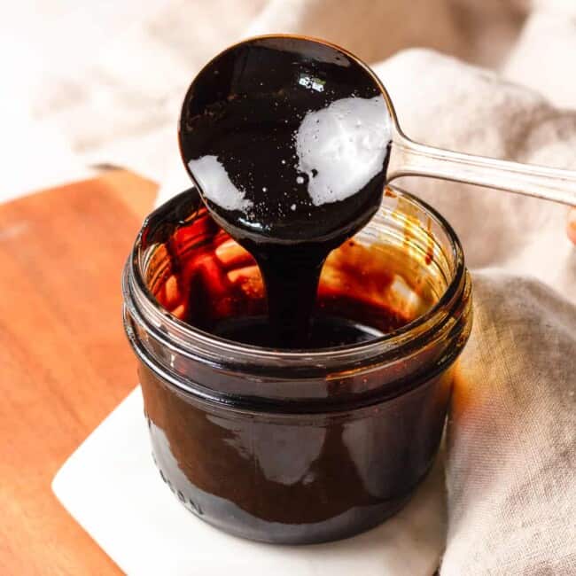 jar of balsamic glaze, spoon dipping into it