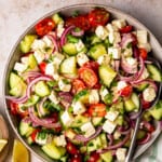 large bowl filled with a colorful cucumber tomato salad