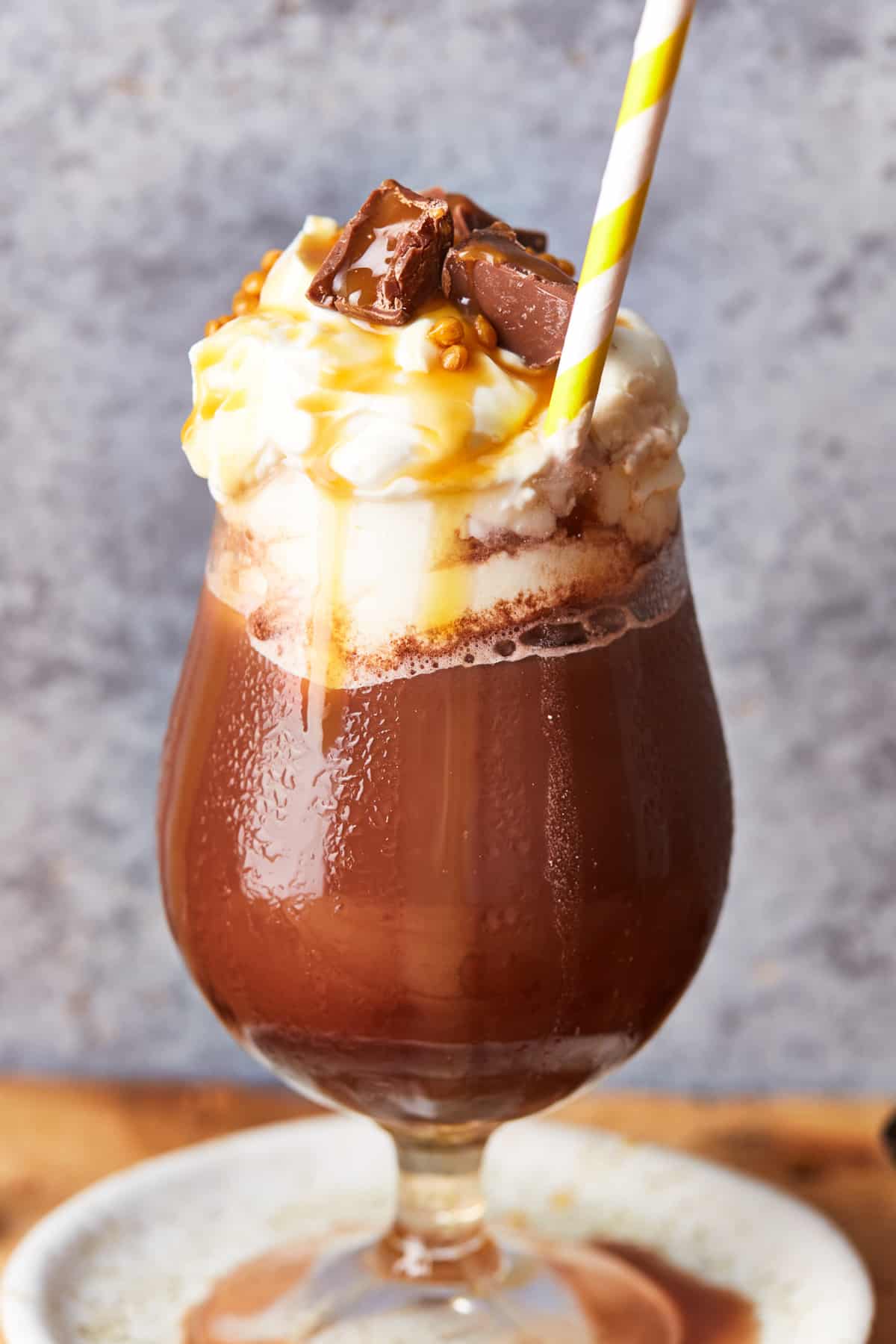 frozen hot chocolate in a glass, topped with whipped cream, chocolate, and caramel