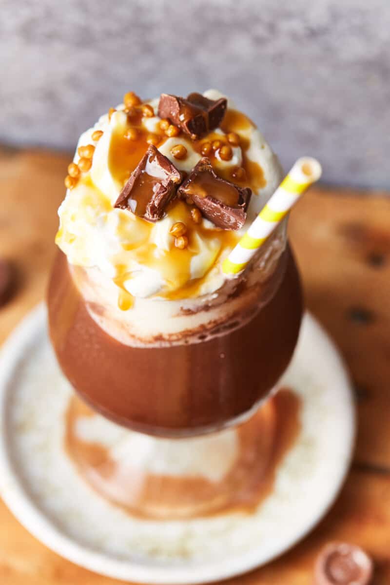 frozen caramel hot chocolate in a cup with a straw