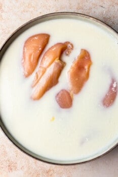 raw chicken breast soaking in buttermilk