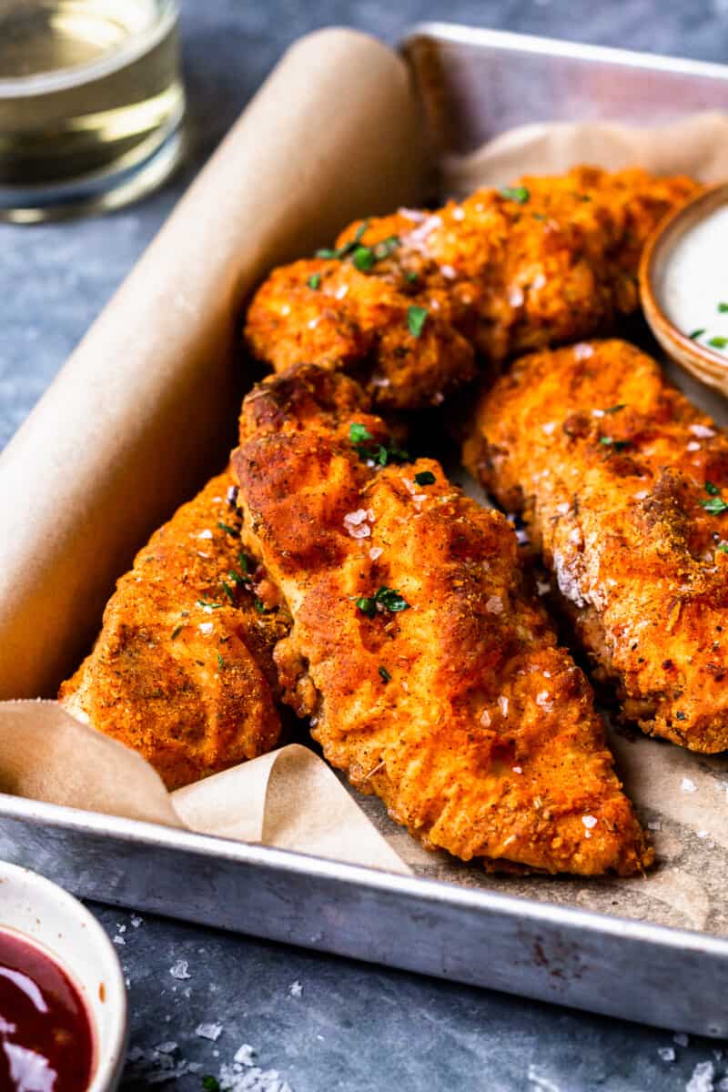breaded oven fried chicken on a tray with parchment paper