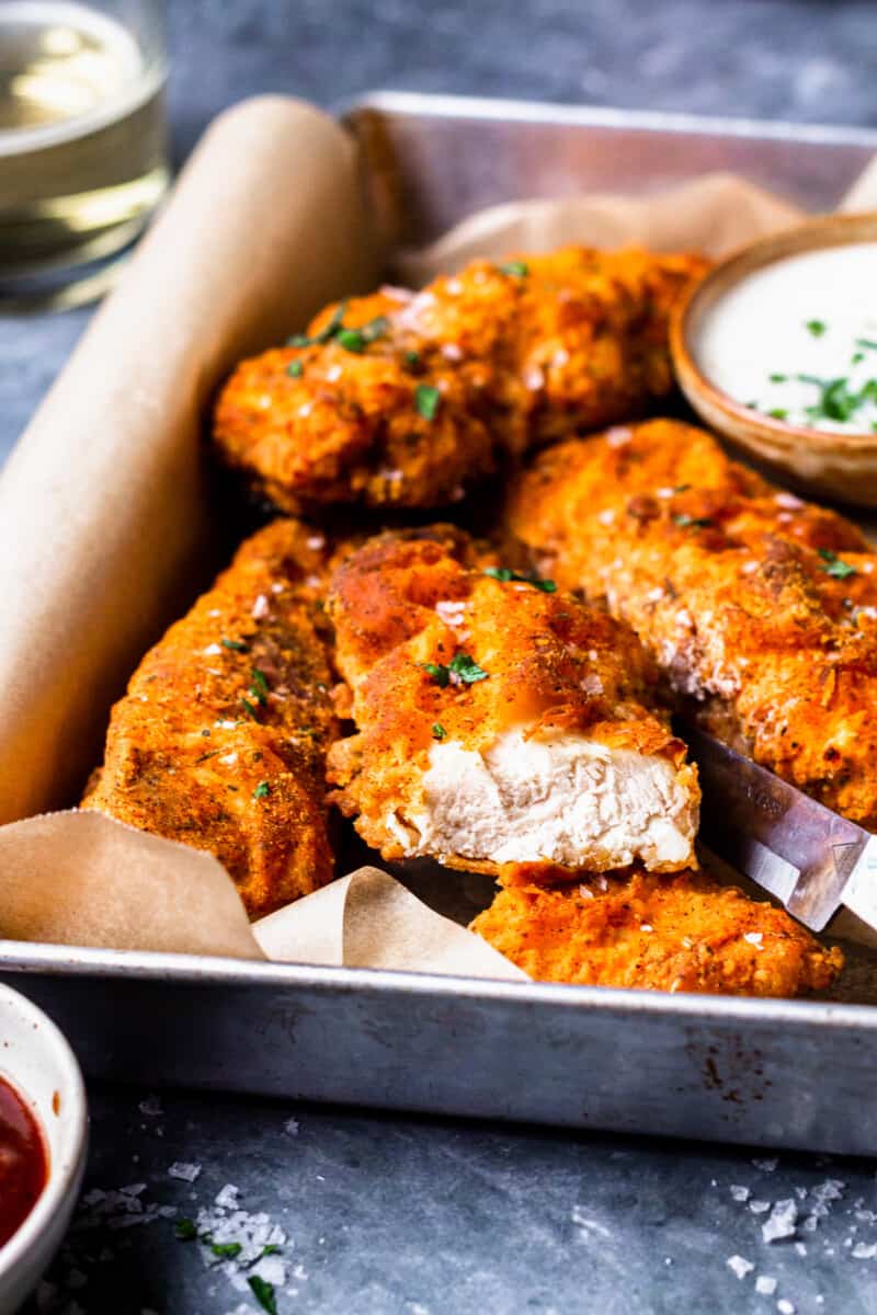 pieces of crispy breaded chicken breast on a tray