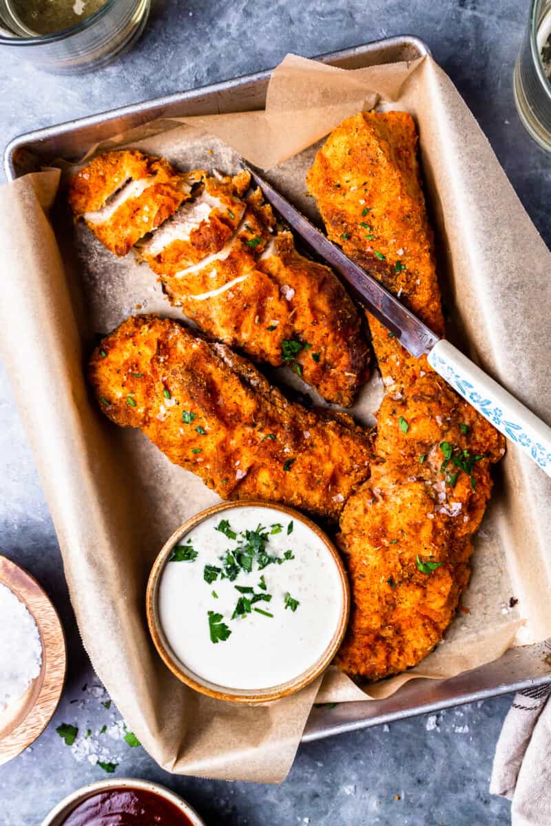 four pieces of oven fried chicken on a tray