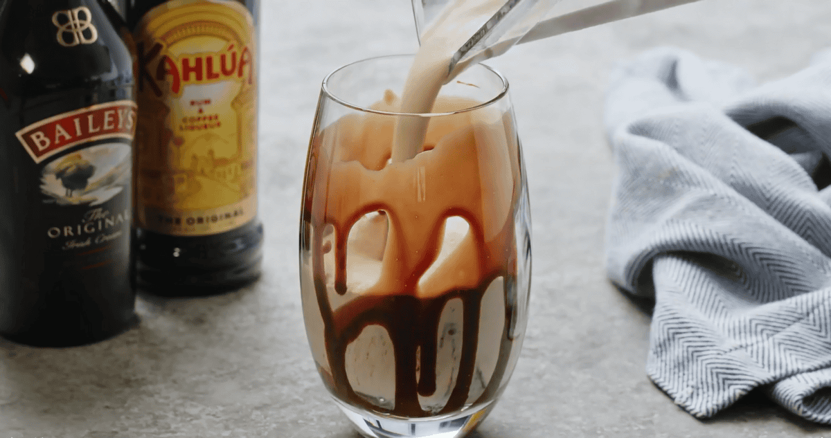 ice cream being poured into drinking glass to make mudslide