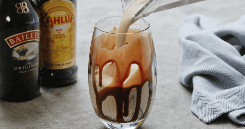 pouring the mudslide mixture into the glasses