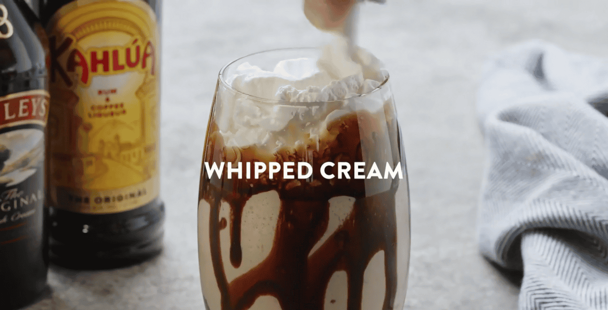 whipped cream being added to mudslide