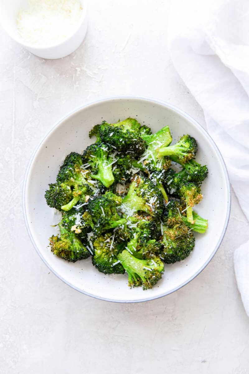 overhead view of air fryer broccoli in a white bowl.