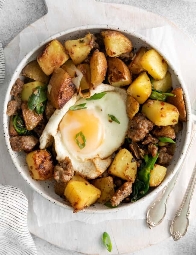 overhead view of breakfast hash in a white bowl.