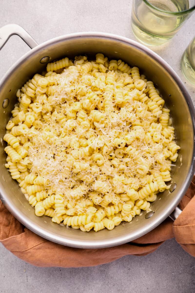 close up of cacio e pepe in a stainless steel pot.