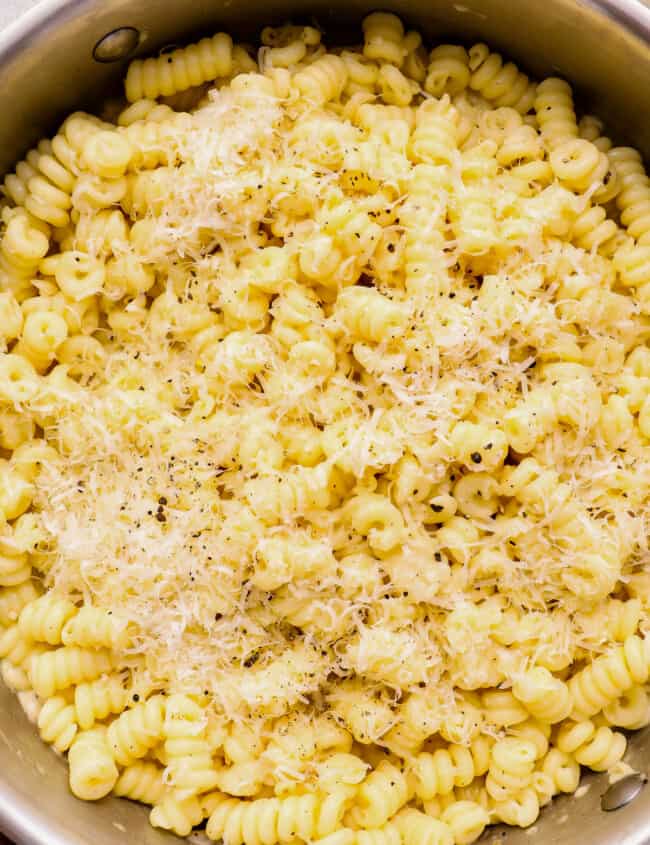 close up of cacio e pepe in a stainless steel pot.