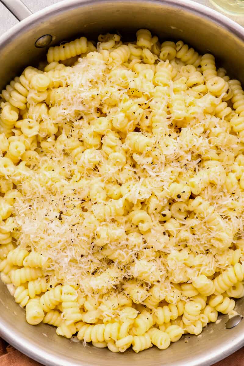 close up of cacio e pepe in a stainless steel pot.