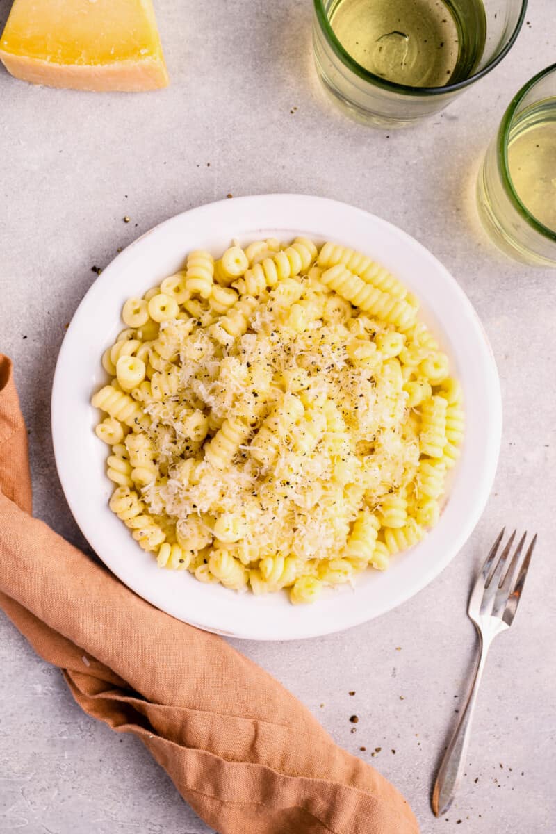 overhead view of cacio e pepe in a white bowl.