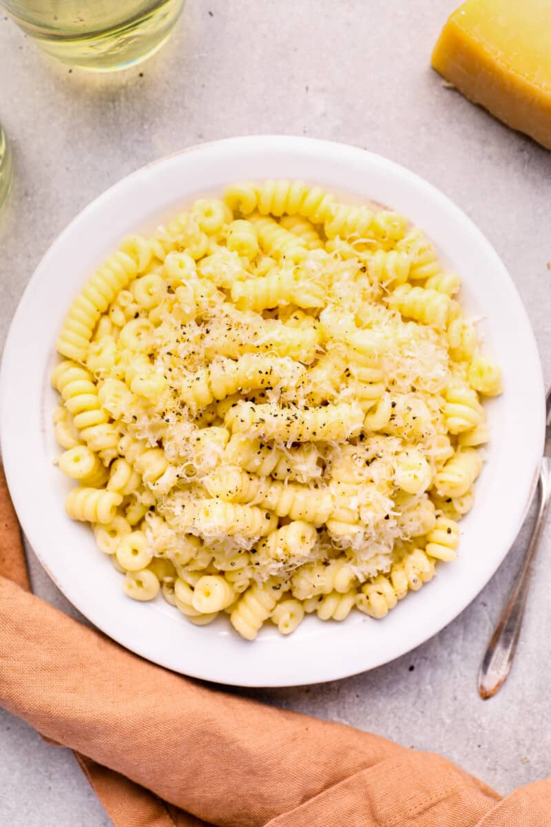 overhead view of cacio e pepe in a white bowl.