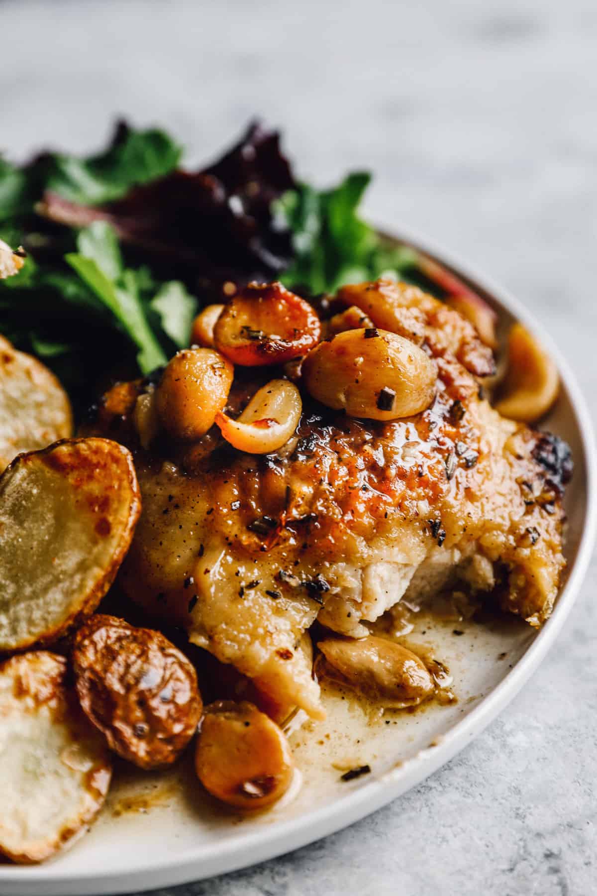 close up on a plate of 40 clove garlic chicken