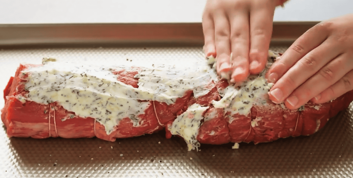Beef tenderloin covered in butter seasoning.