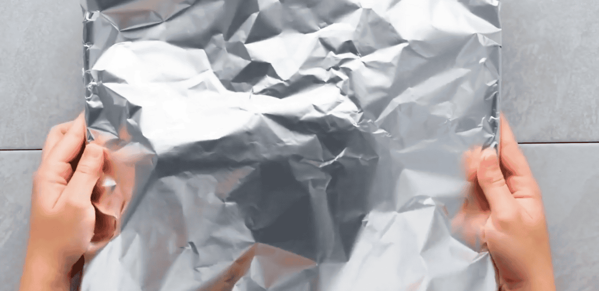 Beef tenderloin covered with foil.