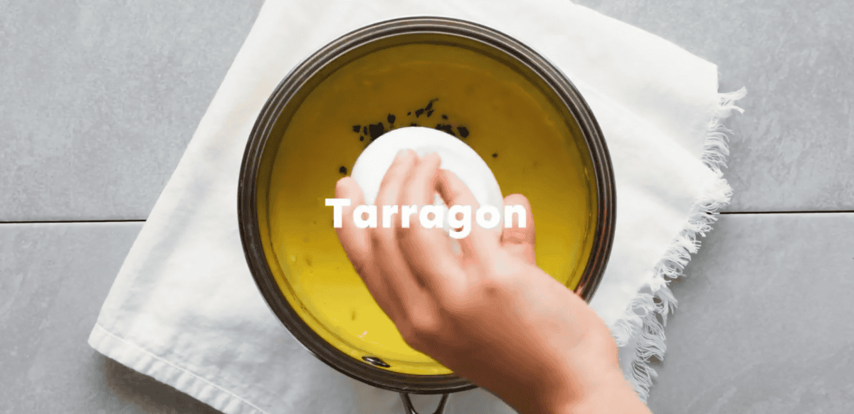 Adding tarragon, salt and pepper to the sauce. 