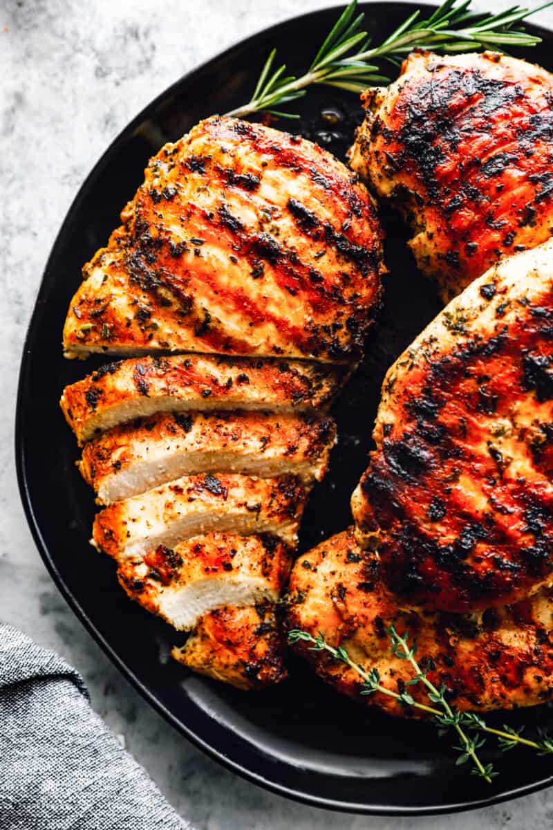 marinated grilled chicken breast sliced on a plate