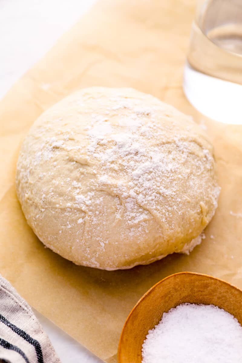 ball of homemade pizza dough on parchment paper