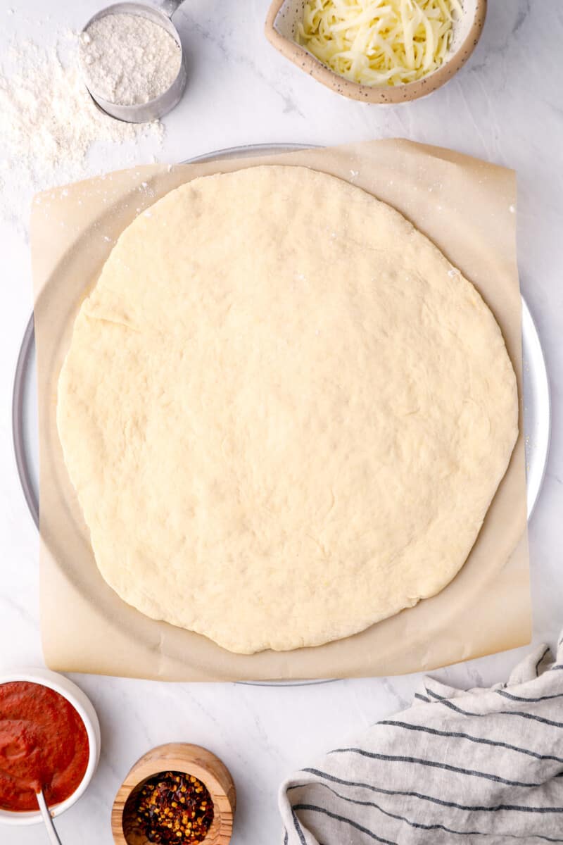 overhead view of homemade pizza dough rolled out into a circle