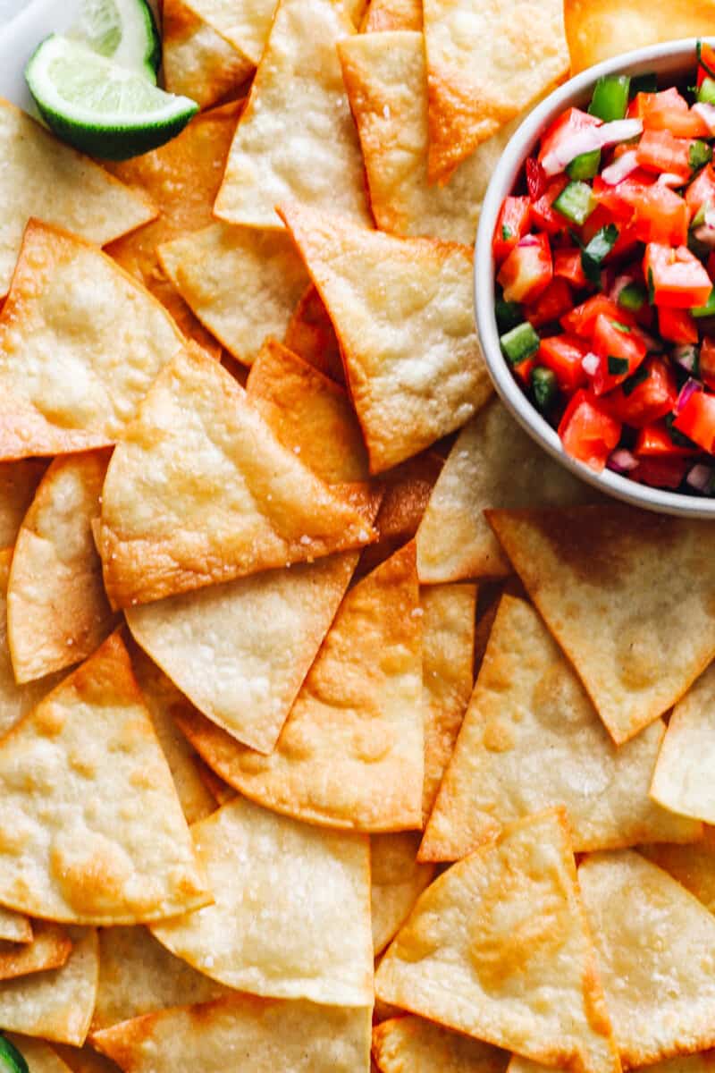 close up of homemade tortilla chips with salsa.