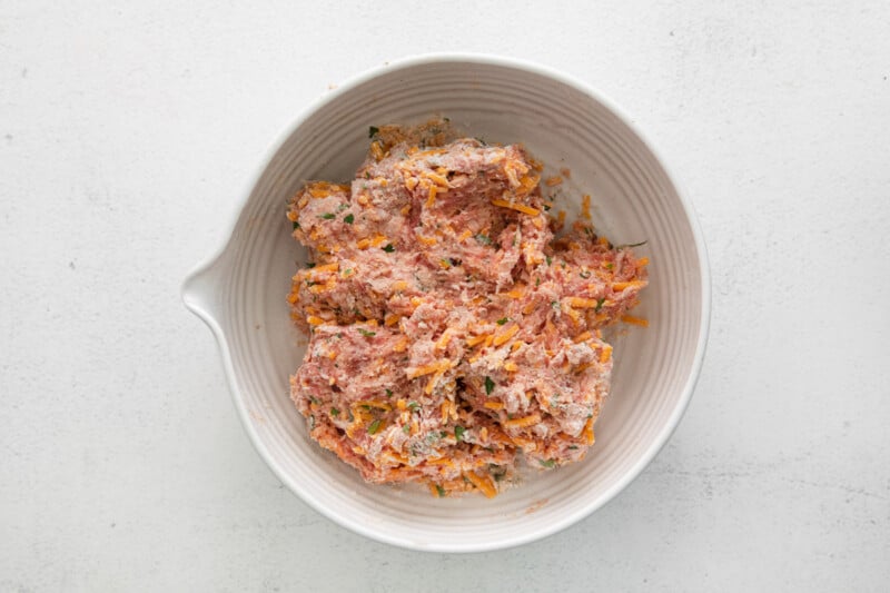 air fryer sausage ball meat in a white bowl.