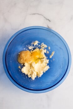 butter, eggs, and applesauce in a bowl